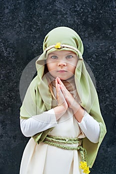 Girl in a Christmas outfit. Attire for the reconstruction of the history of the birth of Jesus Christ. Girl in biblical costume,