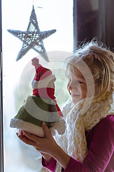 Girl with christmas santa toy