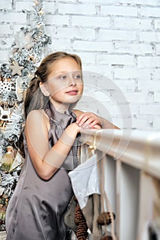 Girl at the Christmas tree