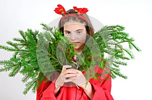 Girl with Christmas tree branches