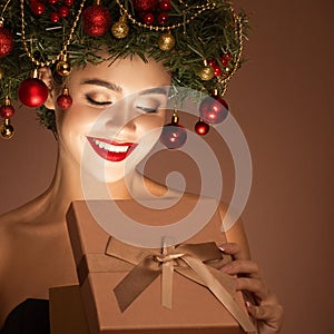 Girl with christmas wreath on her head. Open magic gift box