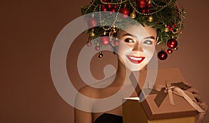 Girl with christmas wreath on her head. Open magic gift box