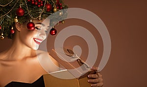 Girl with christmas wreath on her head. Open magic gift box