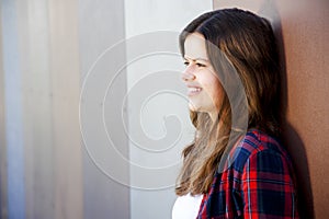 Girl city portrait. Woman smiling outside in evening light by th
