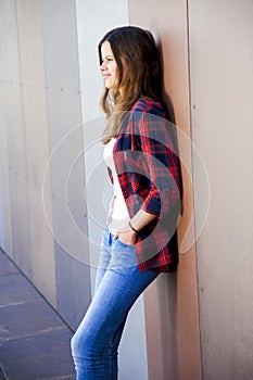 Girl city portrait. Woman smiling outside in evening light by th