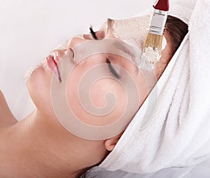 Girl with clay facial mask.