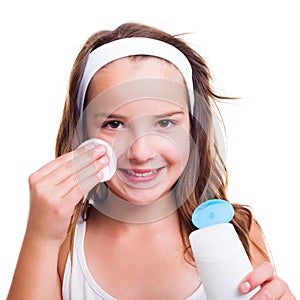 Girl cleaning her face with tonic lotion