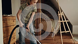 Girl cleaning house with vacuum cleaner