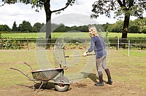 Girl cleaning the manure photo