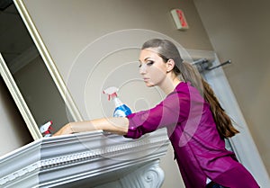 Girl cleaning the window