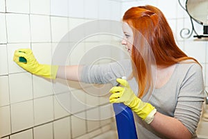 Girl cleans bathroom with sponge