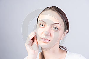 Girl Cleansing her Face Using Cotton with Cleanser