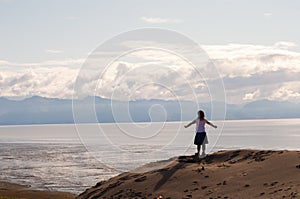 Girl on Cliff with Arms Spread