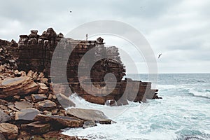 Girl on cliff near sea