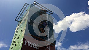 Girl climb on step ladder on a high vertical wall