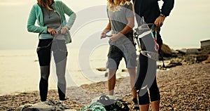 A girl climber puts on a special belay and attaches a special rope to her belt in order to start rock climbing on a