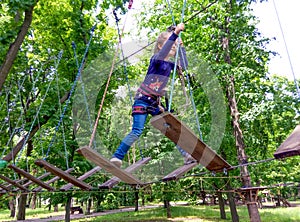 Girl climbing in adventure rope park