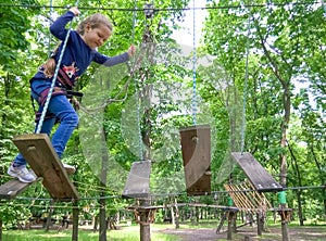 Girl climbing in adventure rope park