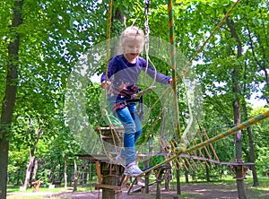 Girl climbing in adventure rope park