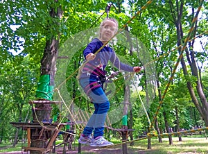 Girl climbing in adventure rope park