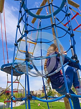 Girl climbing in adventure rope park