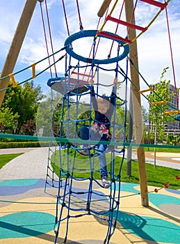 Girl climbing in adventure rope park