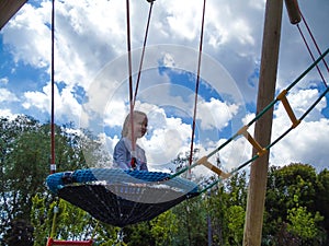 Girl climbing in adventure rope park