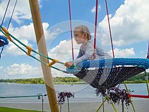 Girl climbing in adventure rope park