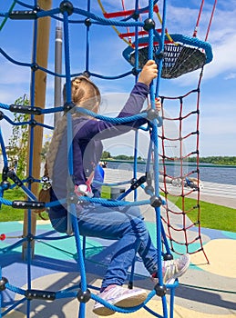 Girl climbing in adventure rope park