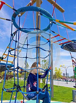 Girl climbing in adventure rope park