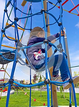 Girl climbing in adventure rope park