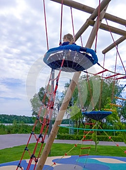 Girl climbing in adventure rope park