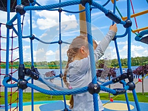 Girl climbing in adventure rope park