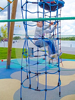 Girl climbing in adventure rope park