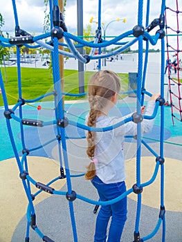 Girl climbing in adventure rope park