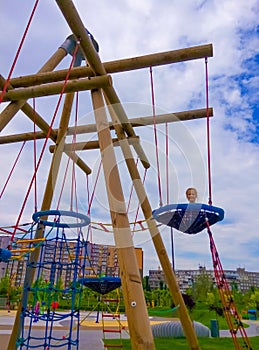 Girl climbing in adventure rope park