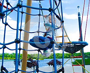 Girl climbing in adventure rope park