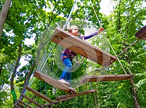 Girl climbing in adventure rope park