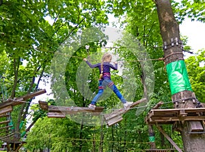 Girl climbing in adventure rope park