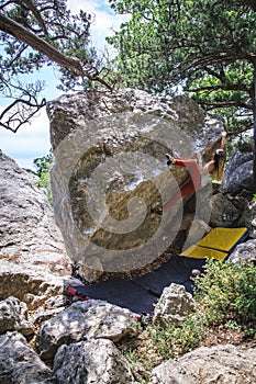 Girl climbing boulder