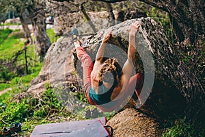 Girl climbing hard boulder problem. Sport climbing, bouldering photo