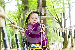 Girl climbing in high rope course