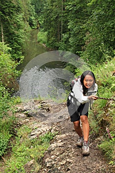 Girl climbing a rock in Slovak Paradise