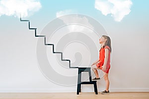 Girl climbing the stairs to heaven photo