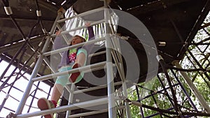 Girl climbing up the ladder on playground