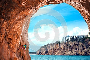 A girl climbs a climbing route