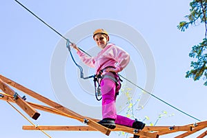 Girl climbs into ropes course