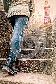 Girl climbs steps of a ladder, atop a bright door. concept of vocation, unknown, destiny