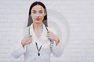 Girl in Clinic with Stethoscope in Bathrobe.