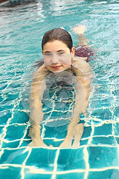 Girl close up portrait in open air swimming pool